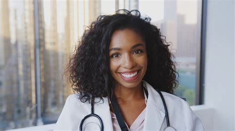 Portrait Of Smiling Female Doctor Wearing White Coat With