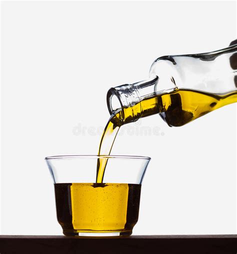 Pouring Olive Oil From A Bottle Into A Glass Stock Image Image Of
