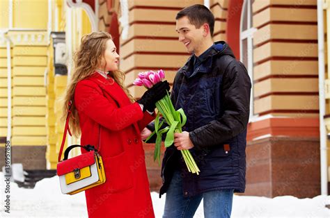 Romantic Date Man Giving Flowers To His Girlfriend Beautiful Young Couple Walking Together