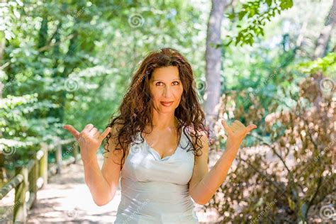 Busty Classy Mature Woman Doing Welcome Shaka Sign Stock Image Image