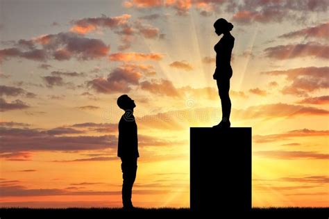 Feminists Standing On A Pedestal Looking Down At The Man Stock Photo