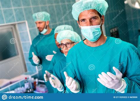 Portrait Of Successful Team Of Surgeon Standing In Operating Room
