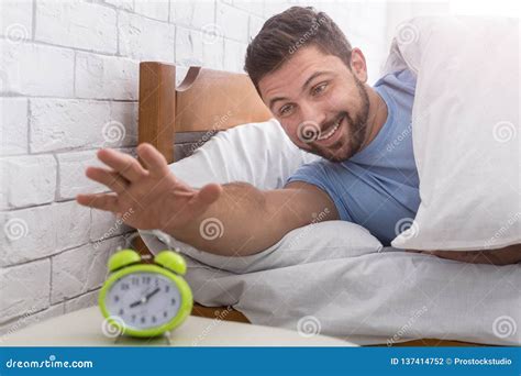 Happy Man Waking Up And Stopping Alarm Clock Stock Photo Image Of