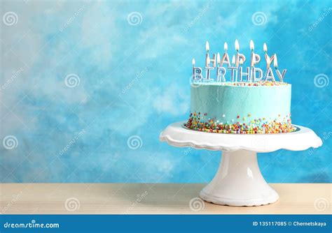 Fresh Delicious Birthday Cake With Candles On Stand Against Color