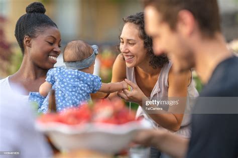 A Group Of Young Adult Friends Dining Al Fresco On A Patio High Res