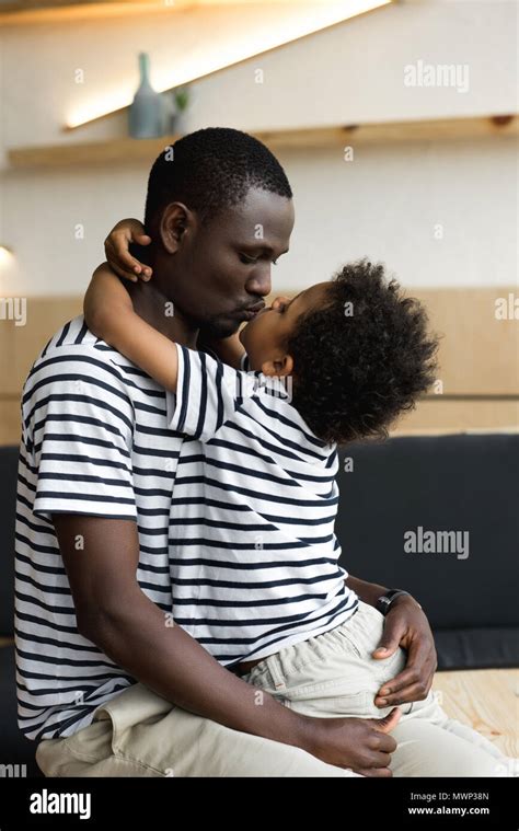 Happy African American Father And Son Hugging And Kissing Together