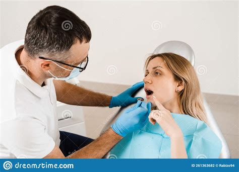 Attractive Woman Afraid Of Dentist Dentist Consults Frightened Girl In