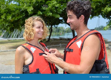 Boyfriend Helping Girlfriend Button Safety Jacket Stock Image Image