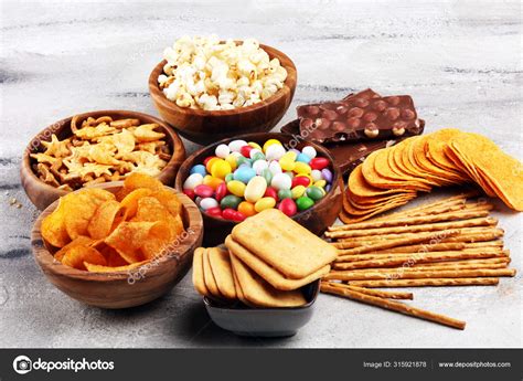 Salty Snacks Pretzels Chips Crackers In Wooden Bowls And Cand Stock