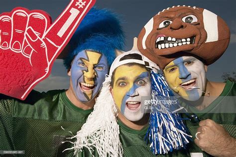 Three Male Football Fans Wearing Face Paint Gesturing High Res Stock