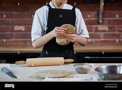 Woman Kneading Dough In Kitchen Stock Photo Alamy