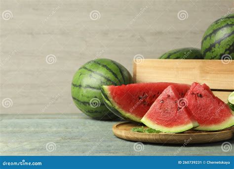 Delicious Ripe Whole And Cut Watermelons On Wooden Table Space For