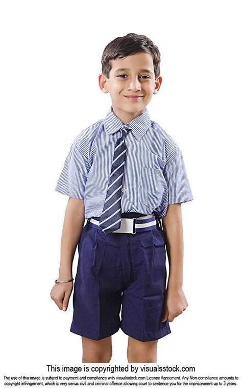 Primary School Kid Boy In School Uniform Standing And Smiling