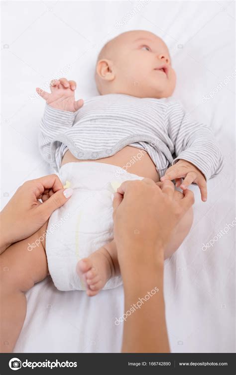 Mother Changing Babys Diaper — Stock Photo © Antonlozovoy 166742890