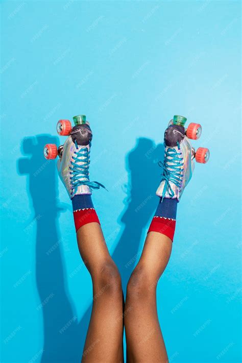 Premium Photo Feminine Legs In A Roller Skates Shoes With Blue Background