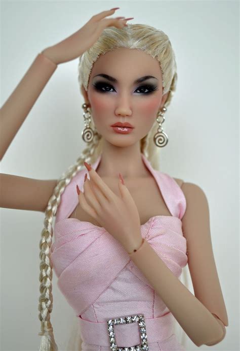 A Barbie Doll Is Wearing A Pink Dress And Holding Her Hand Up To Her Head