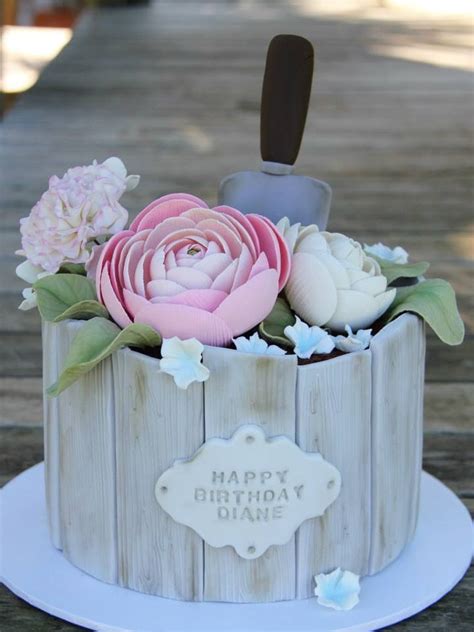 A Birthday Cake Decorated With Flowers On A Table