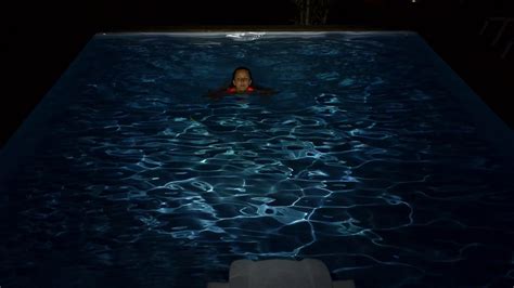 Woman Swims In Swimming Pool At Night Slow Stock Footage Sbv