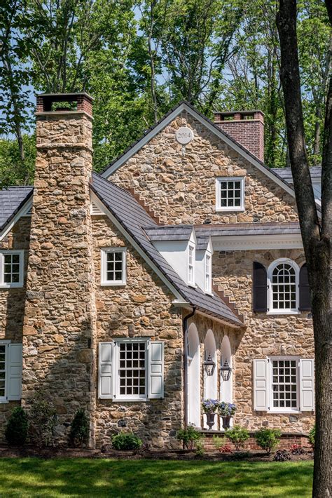 Colonial Revival Stone Farmhouse With Arch Top Window Details In