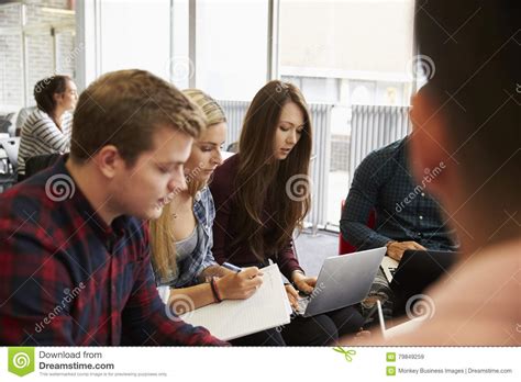 Group Of Students In Library Collaborating On Project Stock Image
