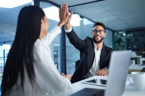 Two Business People High Fiving Stock Photos Pictures And Royalty Free
