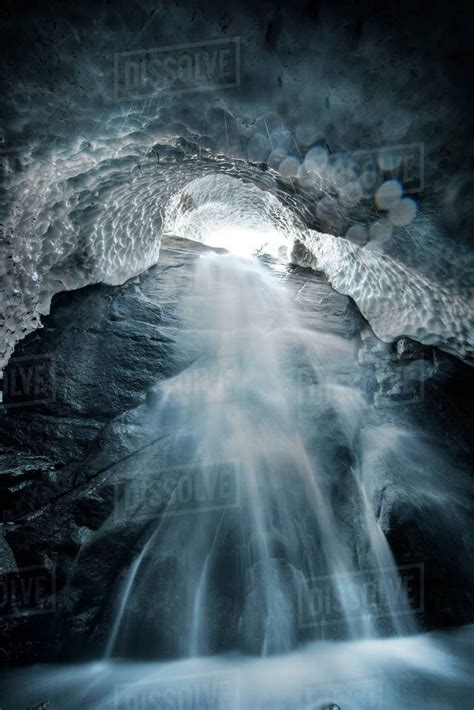 Low Angle View Of Waterfall In Ice Cave Stock Photo Dissolve