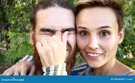 Young Couple Doing Selfie A Guy With A Beard And A Girl With A Short Hair Cut Themselves Off