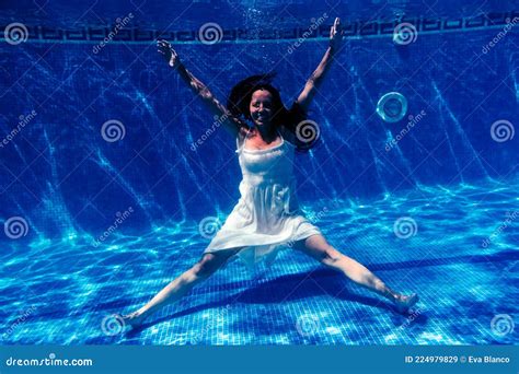 Caucasian Woman Diving In Swimming Pool Wearing White Dressunderwater View Stock Image Image