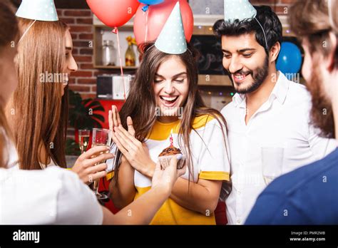 Friends Congratulates Brunette Birthday Girl In Party Hat With Cupcake She Feeling Surprised