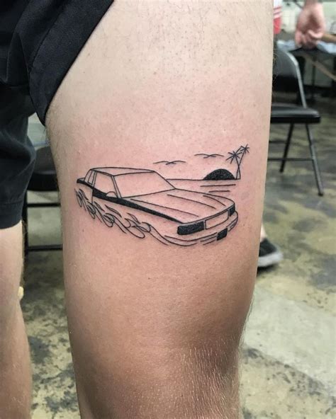 A Mans Leg With A Car Tattoo On It