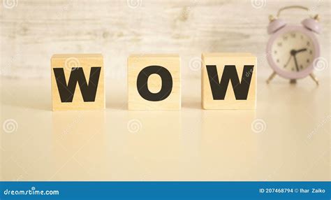 The Word Wow Consists Of Wooden Cubes With Letters Top View On A Light
