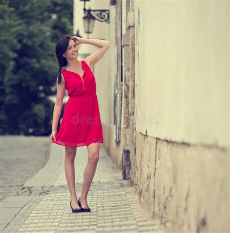 beautiful brunette girl with red outfit stock image image of city