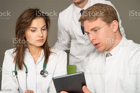Three Doctors Consulting Stock Photo Download Image Now 2015 Adult