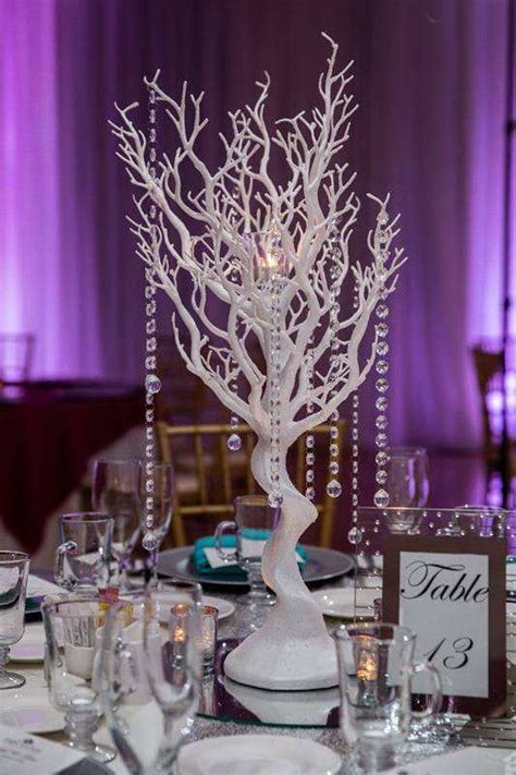 White Manzanita Trees With Hanging Crystals On A Mirror With 3 Candles