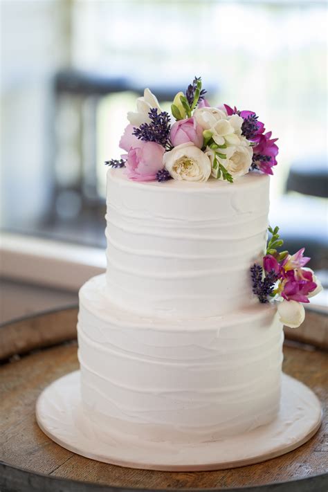 Two tier chocolate overload cake. A classical white two-tier wedding cake comes to life with ...