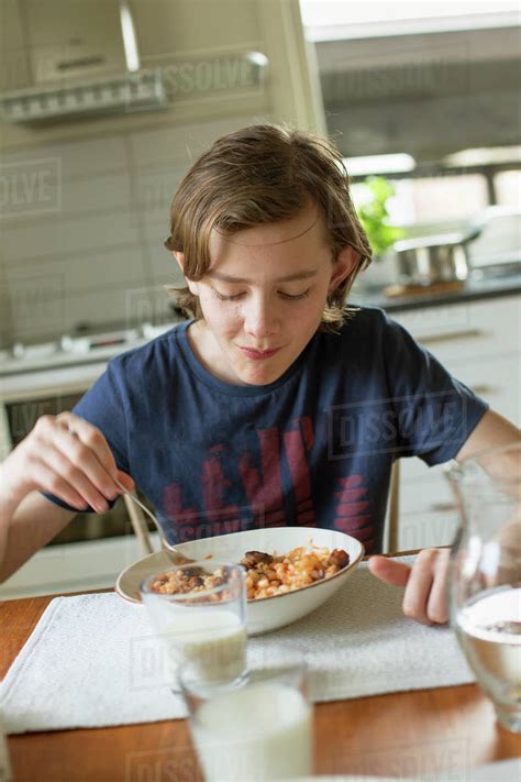 Teenage Boy Eating Breakfast In A House Stock Photo Dissolve