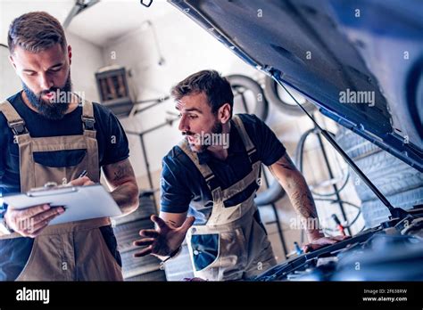 Young Auto Mechanic Repairing Car Engine In Workshop Stock Photo Alamy