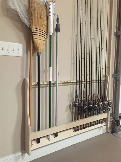 A Broom And Some Fishing Rods Hanging On The Wall