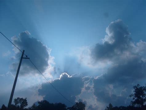Free Photo Sun Behind Clouds Blue Clouds Rays Free Download Jooinn