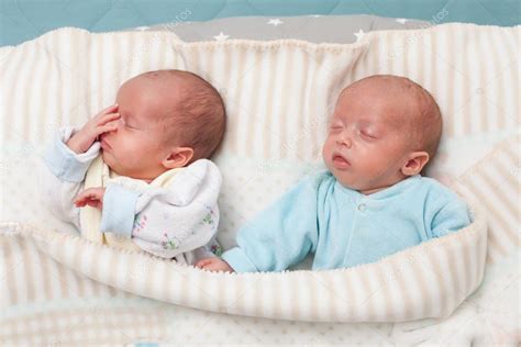 Two Adorable Twin Babies Sleeping In The Bed Closeup Portrait