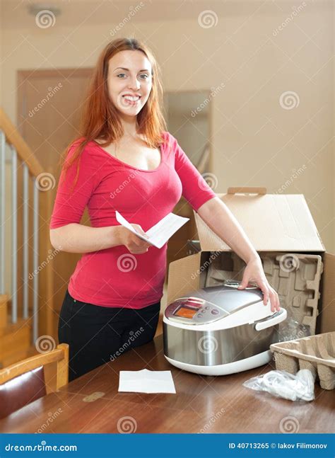 Young Red Haired Housewife Unpacking New Multicooker In Living R Stock Image Image Of Read