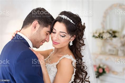 The Groom Gently Embraces And Kisses The Bride Stock Photo Download