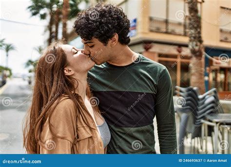 Young Interracial Couple Kissing And Hugging Standing At The City Stock