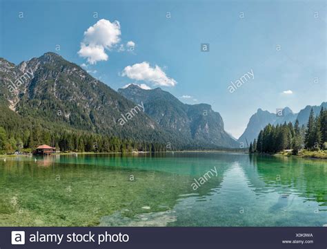 Typical for south tyrol will a few travellers think looking at the village in the middle of wide meadows and surrounded by high dolomites rocks. Toblach,Dobbiaco,Italia,Lake Toblach Stock Photo ...