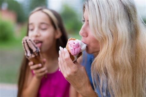 Free Photo Mother And Daughter Eating Ice Cream Together