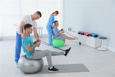 Professional Physiotherapists Working With Patients Stock Photo Image