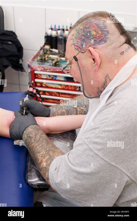 Tattoo Artist At Work In His Studio On A Client Stock Photo Alamy
