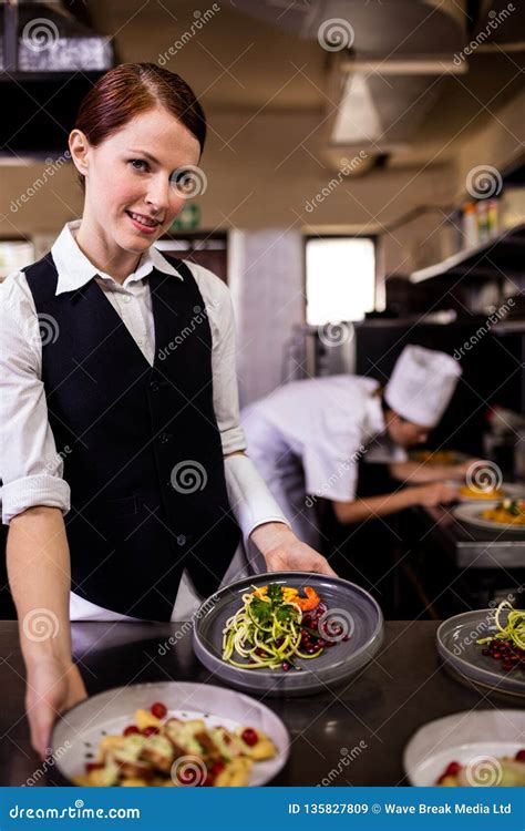 Female Waitress Holding Plates With Food In Kitchen Stock Image Image