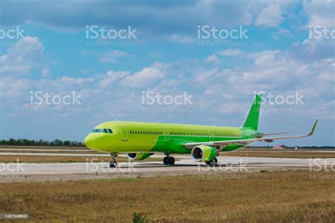 Green Plane On The Runway Evacuation Of The Population Stock Photo