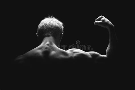 Handsome Power Athletic Man In Dramatic Light Strong Bodybuilder With